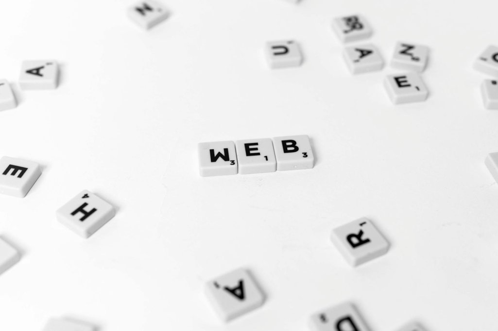 white and black scrabble tiles on a white surface